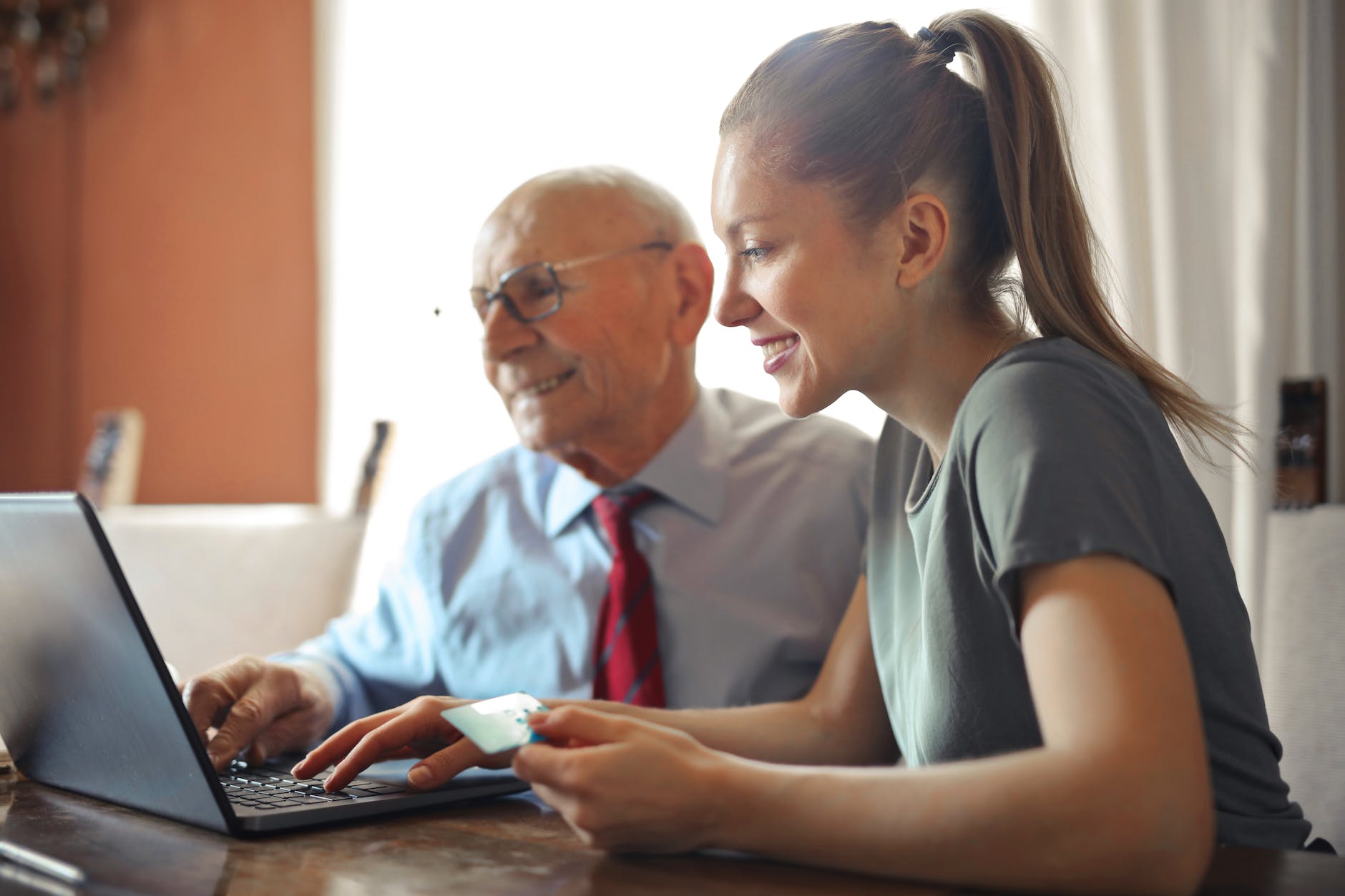 Exploring the Best Make Money Online Programs: Your Path to Financial Freedom 1 young woman helping senior man with payment on internet using laptop