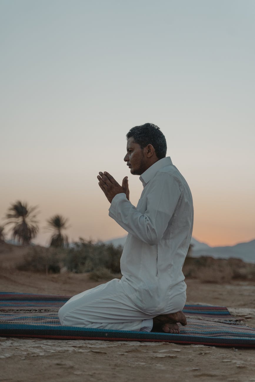 photo of man praying during dawn